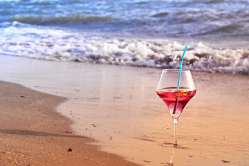 Wine glass with a cocktail by the sea.