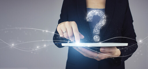 FAQ frequently asked questions concept. White tablet in businesswoman hand with digital hologram...