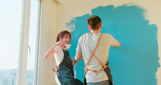 couple painting wall
