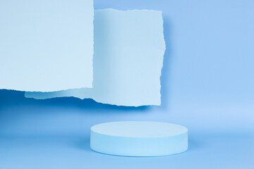 Abstract monochrome composition with empty round podium platform for product presentation and torn paper edges on light blue background. Front view