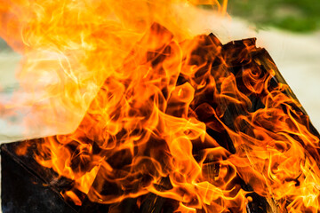Empty hot charcoal barbecue grill with bright flame. Hot burning grill, outdoors cooking food