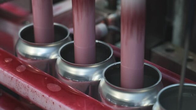 The filling cans with drinks on a manufactory