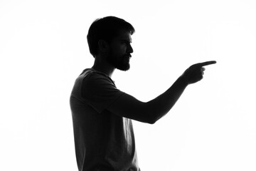 silhouette of a man gestures with his hands black and white photo