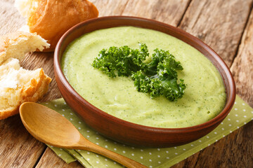 Light dietary cream soup made from kale cabbage close-up in a bowl on the table. horizontal