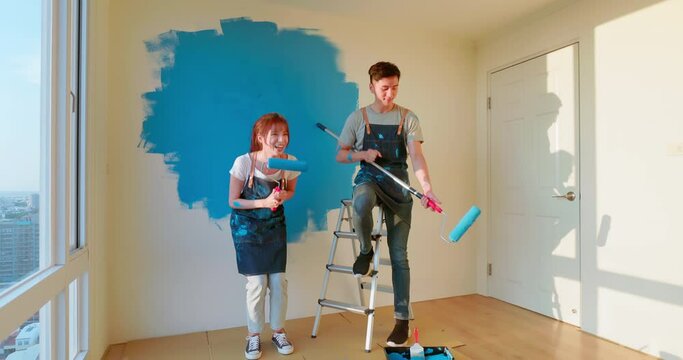 couple painting wall