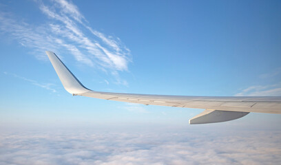 Airplane wing in the sky, modern traveling