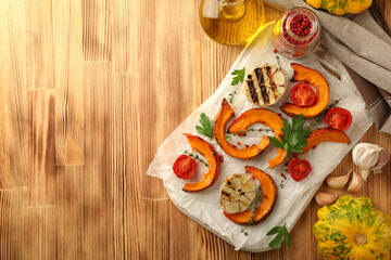 Concept of cooking with baked pumpkin on wooden background