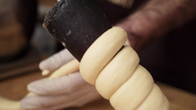 Trdelnik pastry made by using rolled dough, close-up instructions