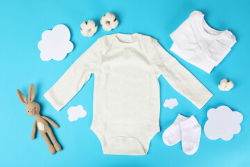 Concept of cute baby clothes on blue background