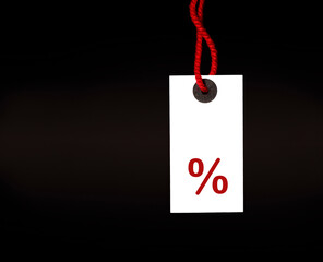 white tag with percent sign on black background