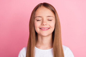 Fototapeta premium Photo of cute blond little girl closed eyes wear white t-shirt isolated on pink color background