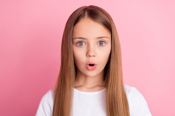 Photo of staring blond small girl look wear white t-shirt isolated on pink color background