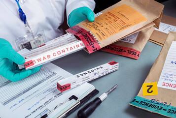 Forensic police check files against evidence in crime lab, conceptual image