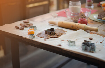 New Year's ginger cookies, dough on the table, flour, tangerines, close up.