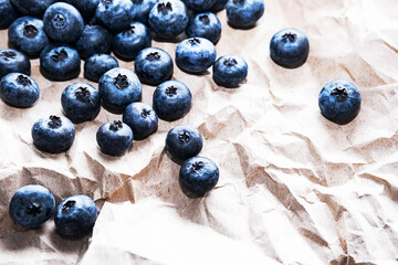 Organic, ripe blueberries on the brown craft paper, close up, copy space. Healthy snack, food background.	