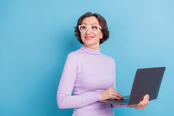 Profile side photo of mature woman happy positive smile use laptop chief isolated over blue color background