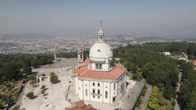 Aerial panning shot capturing monumental architecture sanctuary of sameiro and scenic cityscape.