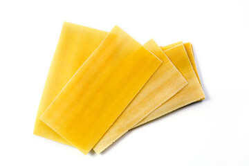 Uncooked raw lasagna pasta isolated on white background. Stack of dried uncooked lasagna pasta sheets