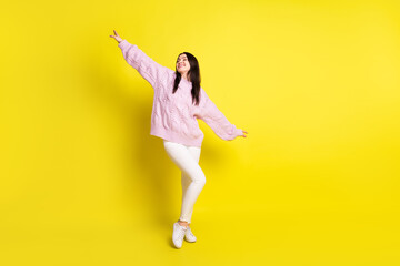 Fototapeta na wymiar Full body photo of millennial brown hairdo lady dance wear pink sweater pants sneakers isolated on yellow color background