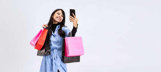 One beautiful young girl shopping while black friday sales. Model with lots of bags, colorful...