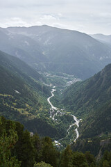 Curved road crossing a valley seen from above