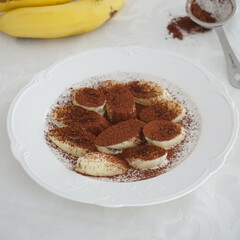 Cocoa-coated banana snack serving in white plate