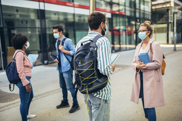 Distance learning. Social distance. New normal life. University students standing outdoor.