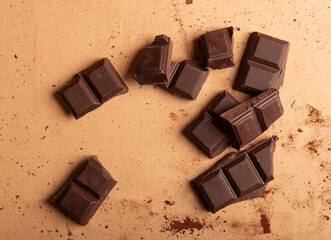 Chocolate with plate on brown rustic background