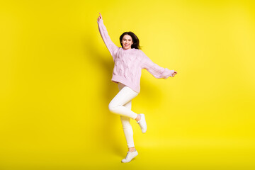 Fototapeta na wymiar Full size photo of hooray millennial lady dance wear sweater pants isolated on yellow color background