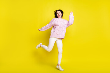 Fototapeta na wymiar Full body photo of astonished millennial lady dance wear sweater pants isolated on yellow color background