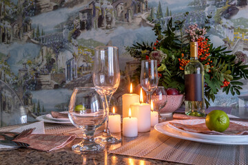  Interior of  kitchen in studio apartments with a served table with wine, fruit and candles