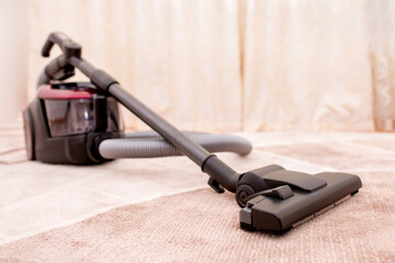 Vacuum cleaner in the room on the carpet, cleanliness in the house, cleaning