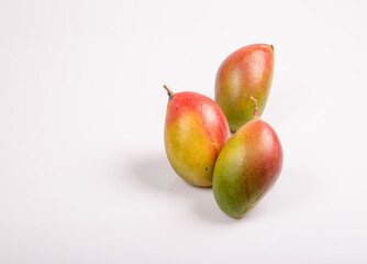 Three mango on white table