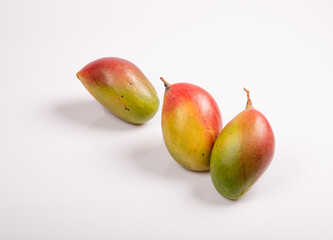 Three mango on white table