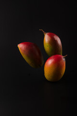 Three mango on elegant black table