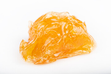 yellow wax piece with high THC  isolated on white background.