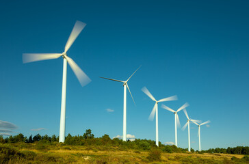 Wind farm, modern windmills on a bright and sunny day