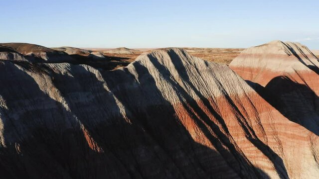 Teepees of Painted Desert with blue sky at Arizona - aerial drone flying shot
