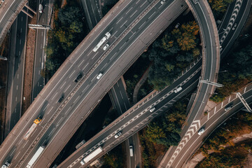 Vehicles Driving on a Spaghetti Junction Interchange in the UK at Sunset - obrazy, fototapety, plakaty