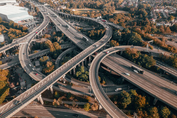 Vehicles Driving on a Spaghetti Junction Interchange in the UK at Sunset - obrazy, fototapety, plakaty