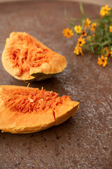 Yellow pumpkins on rustic plate with natural light