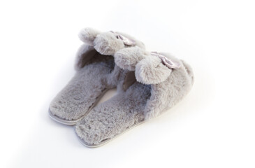 Fototapeta na wymiar Slippers in the shape of a bunny with ears isolated on a white background, women's or children's indoor clothing, cute fluffy fur slippers home