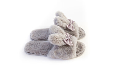 Slippers in the shape of a bunny with ears isolated on a white background, women's or children's indoor clothing, cute fluffy fur slippers home