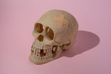 a replica of a human skull with a band-aid