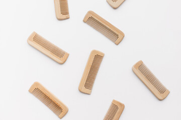 wooden combs scattered isolated on white background, flat lay, top view