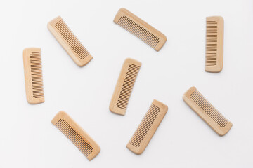 wooden combs scattered isolated on white background, flat lay, top view