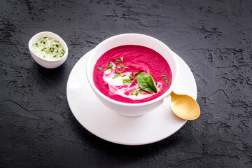 Cream soup made of red beet roots with basil