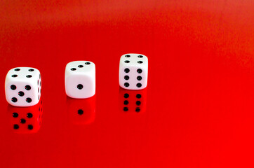 Group of white dice reflected in red background