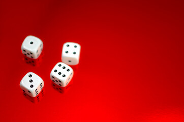 Group of white dice reflected in red background