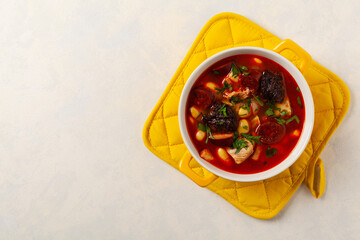 Traditional Spanish goulash soup. Fabada Asturiana. Served with a yellow clay pot with lid. Top...